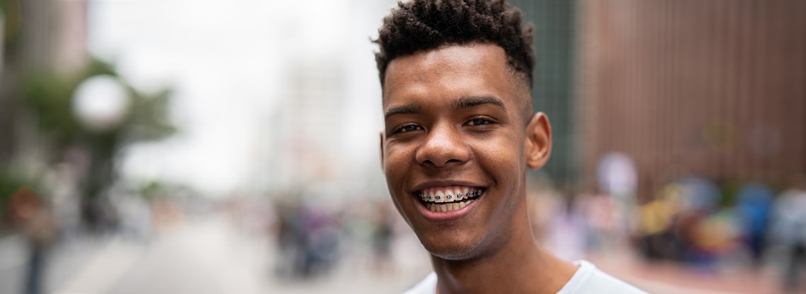 Teen boy with braces smiling